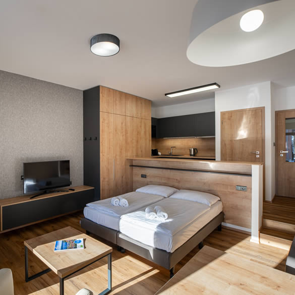 Obývací místnost s dvojlůžkem ve studiovém apartmánu v Landal Marina Lipno